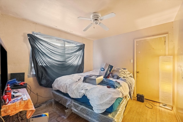 bedroom with hardwood / wood-style floors and ceiling fan