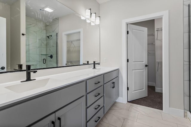bathroom with a sink, marble finish floor, double vanity, and a shower stall