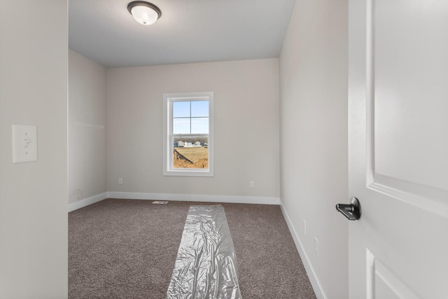 carpeted empty room with baseboards