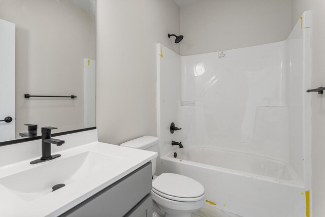 full bath featuring vanity, toilet, and washtub / shower combination