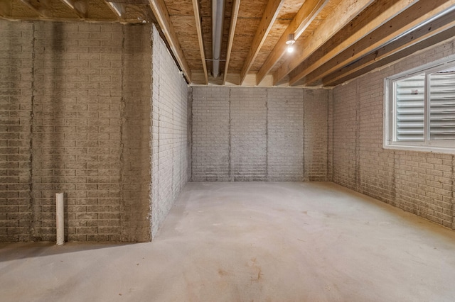 below grade area with brick wall