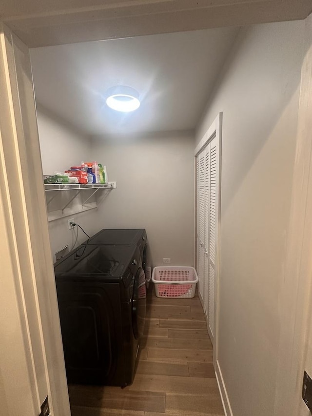 laundry room featuring separate washer and dryer and hardwood / wood-style floors