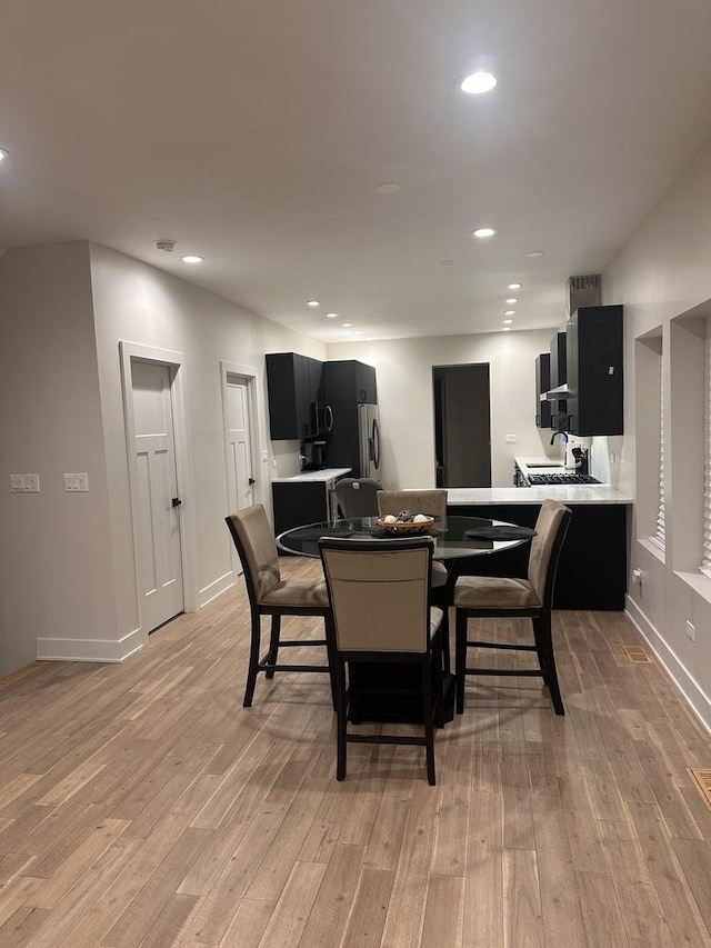 dining area featuring sink and light hardwood / wood-style flooring