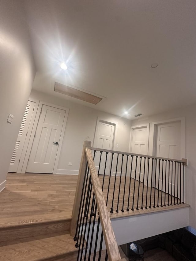 stairway featuring wood-type flooring