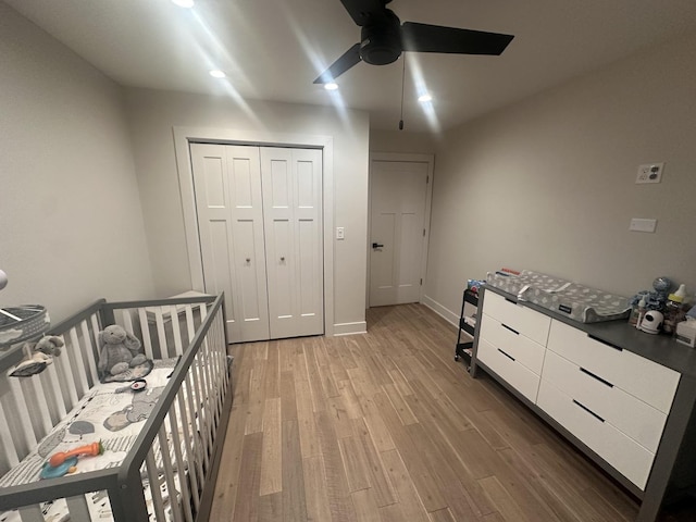 bedroom featuring hardwood / wood-style floors, ceiling fan, and a closet