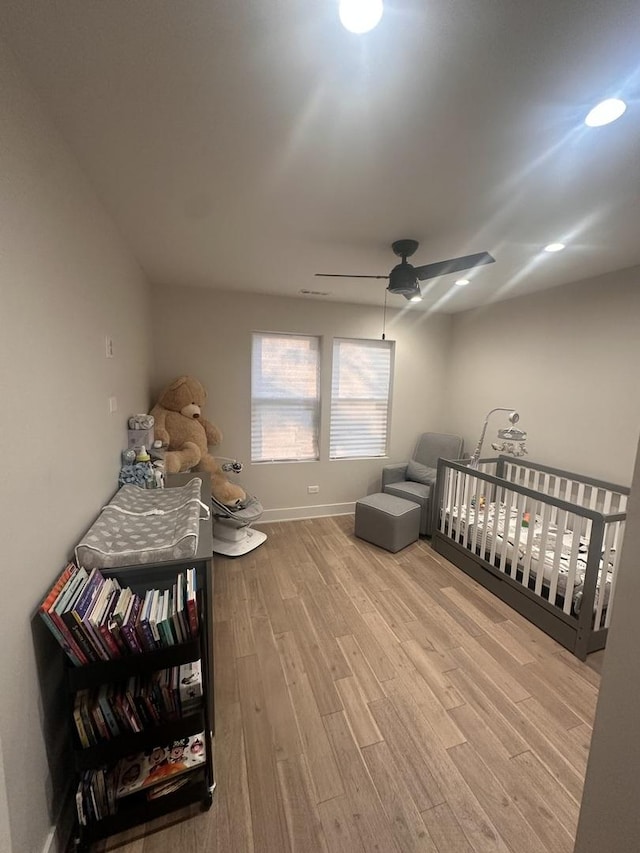 bedroom with ceiling fan and light hardwood / wood-style floors