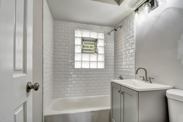 full bathroom with vanity, toilet, and tiled shower / bath combo