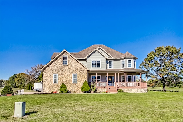 view of front facade with a front yard and covered porch