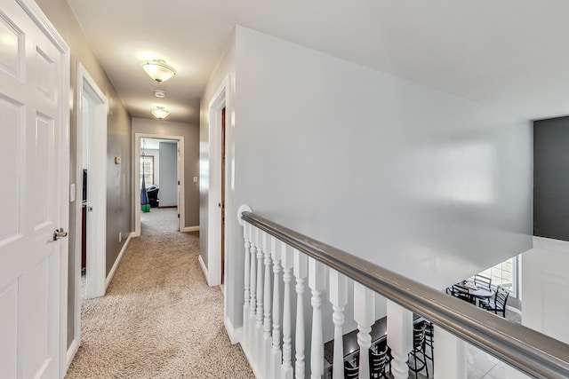 corridor featuring light colored carpet