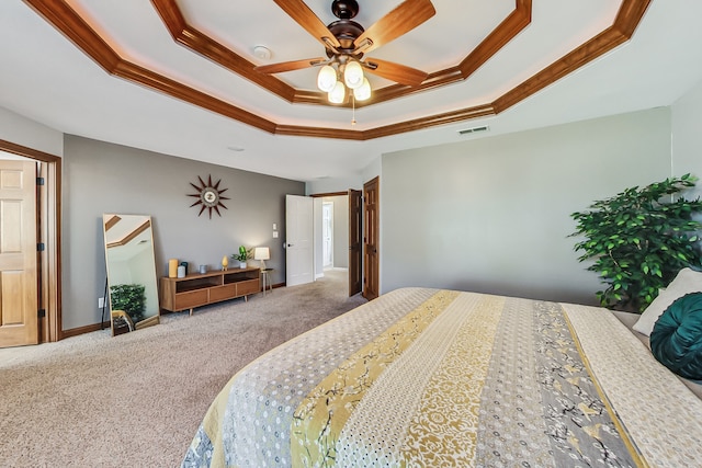 carpeted bedroom featuring ornamental molding, ceiling fan, and a tray ceiling