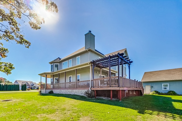 back of house featuring a lawn and a pergola