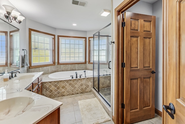 bathroom with a notable chandelier, tile patterned floors, vanity, and independent shower and bath