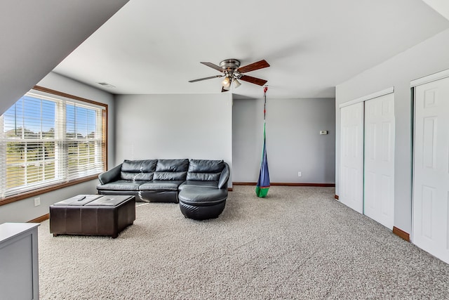 living room with ceiling fan and carpet flooring