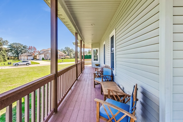 deck featuring a lawn and covered porch