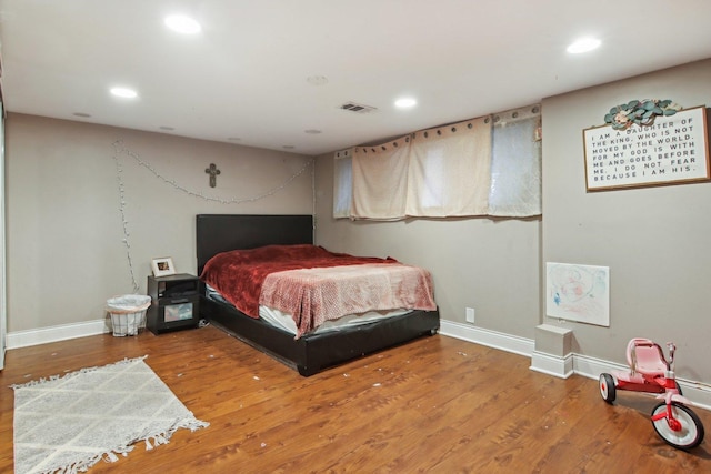 bedroom featuring recessed lighting, visible vents, and wood finished floors