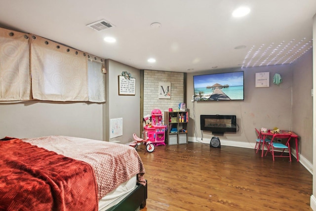 bedroom with recessed lighting, visible vents, baseboards, and wood finished floors