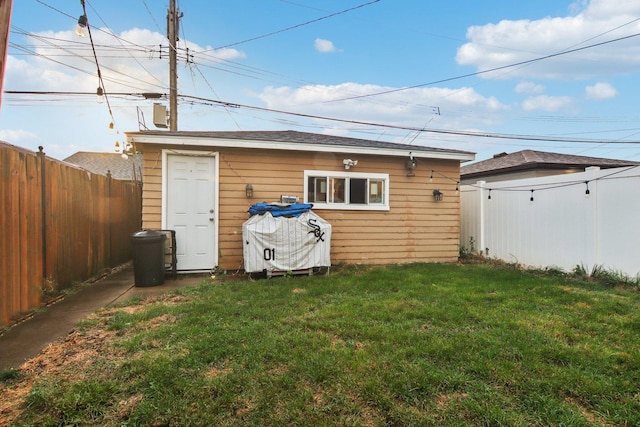 exterior space featuring an outbuilding and a fenced backyard