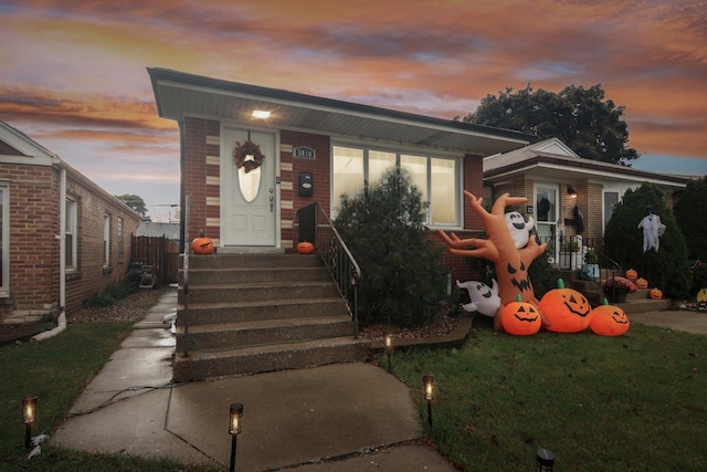 view of front of property featuring a front lawn and brick siding