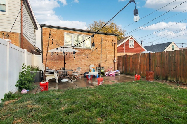 view of yard featuring a patio area and a fenced backyard