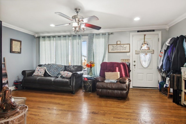 living room featuring ceiling fan, ornamental molding, and hardwood / wood-style floors