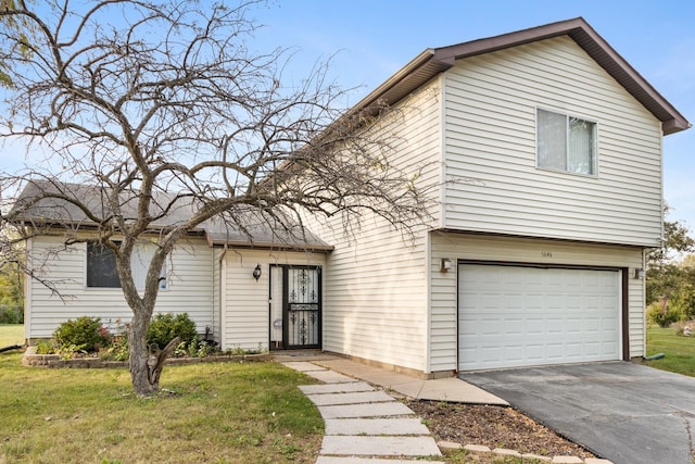 view of front of house featuring a front yard and a garage