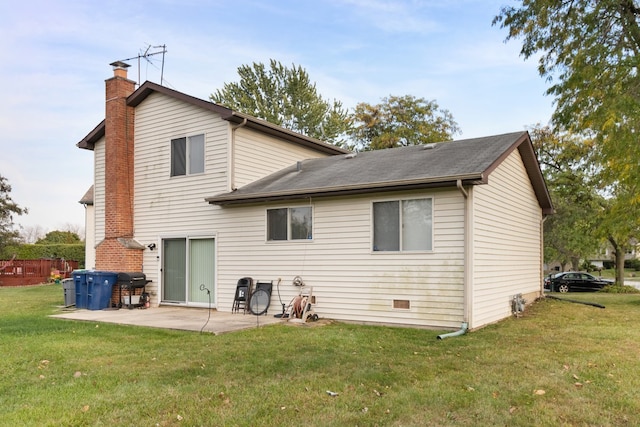 rear view of property featuring a lawn and a patio