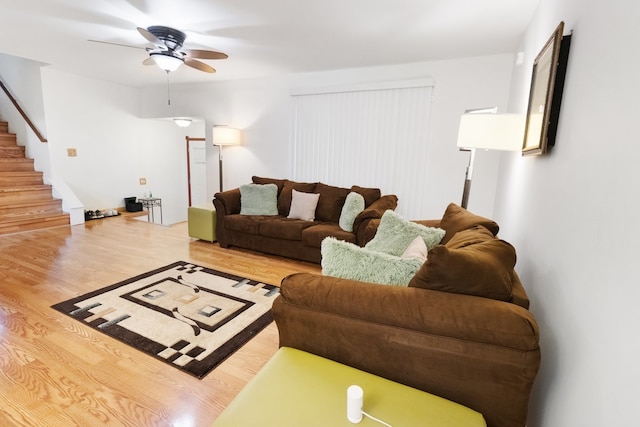 living room featuring ceiling fan and light hardwood / wood-style floors