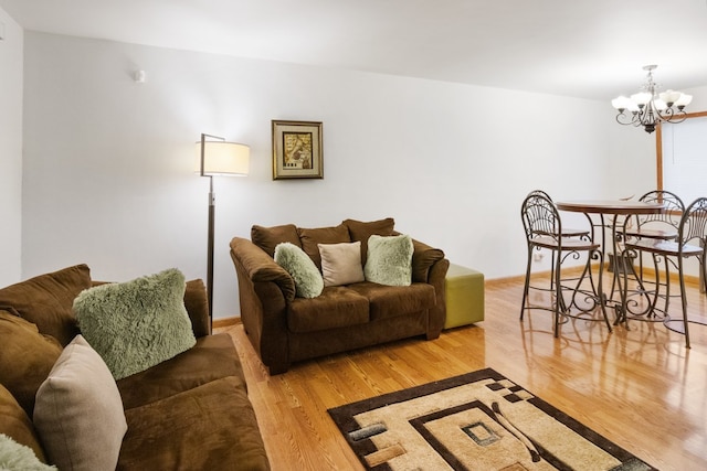 living room featuring wood-type flooring and a notable chandelier