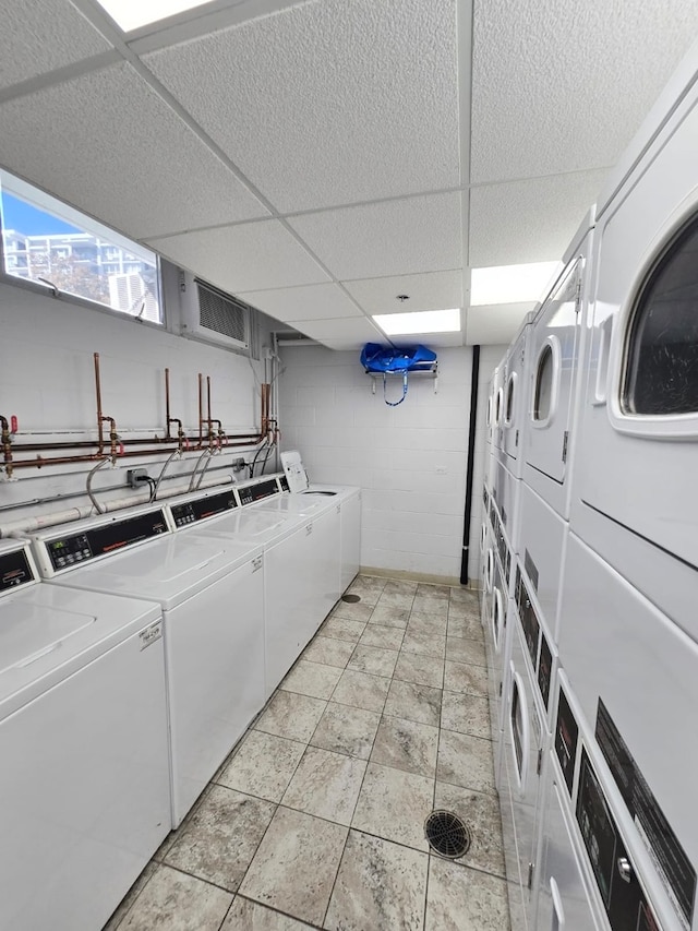 clothes washing area with independent washer and dryer and stacked washer and clothes dryer