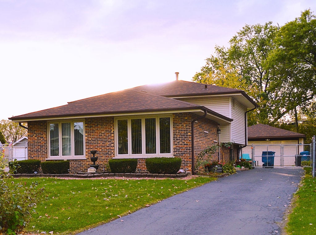 view of front facade with a yard and a garage