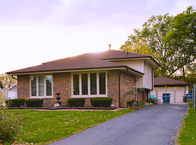 view of front facade with a yard and a garage