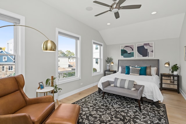 bedroom featuring ceiling fan, vaulted ceiling, and light hardwood / wood-style flooring