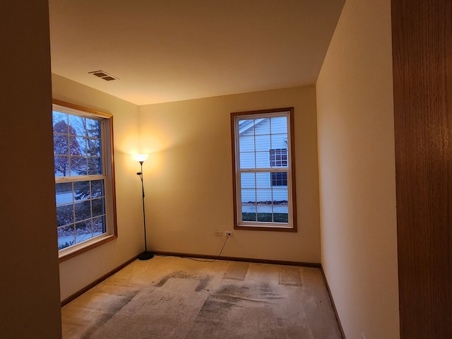 unfurnished room with light carpet