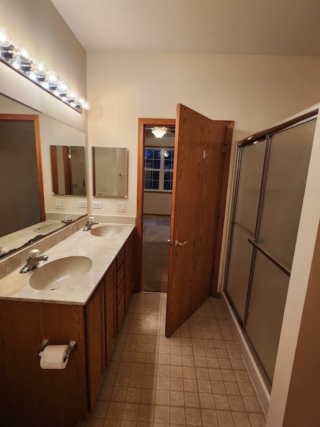 bathroom featuring walk in shower and vanity