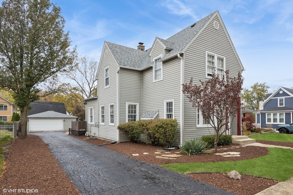 view of home's exterior with an outdoor structure and a garage