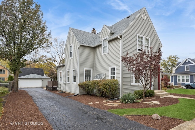 view of front of house featuring an outdoor structure and a garage