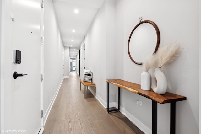 corridor with hardwood / wood-style flooring