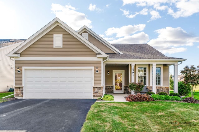 craftsman house featuring a front lawn, covered porch, and a garage