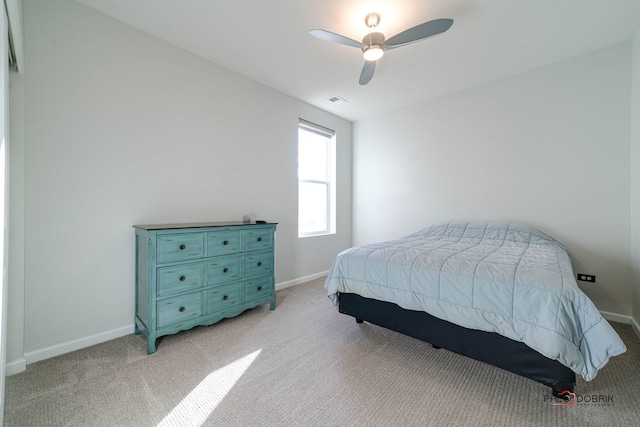 bedroom with ceiling fan and light colored carpet