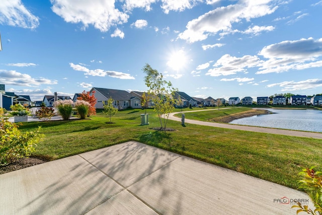 view of community with a yard and a water view