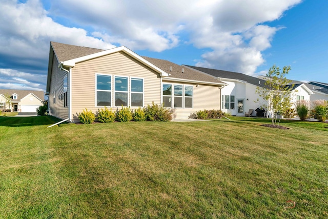 back of property featuring a lawn