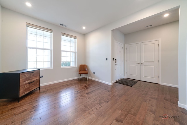 entryway with dark hardwood / wood-style flooring