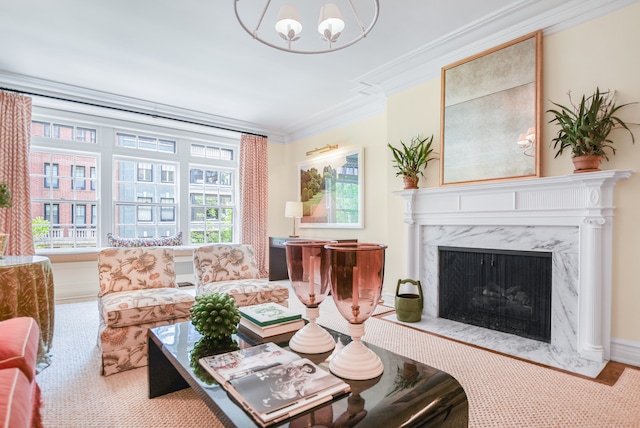 living room with crown molding, a fireplace, and a notable chandelier