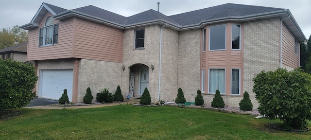 view of front facade with a garage and a front lawn