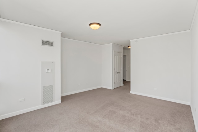 carpeted spare room with crown molding