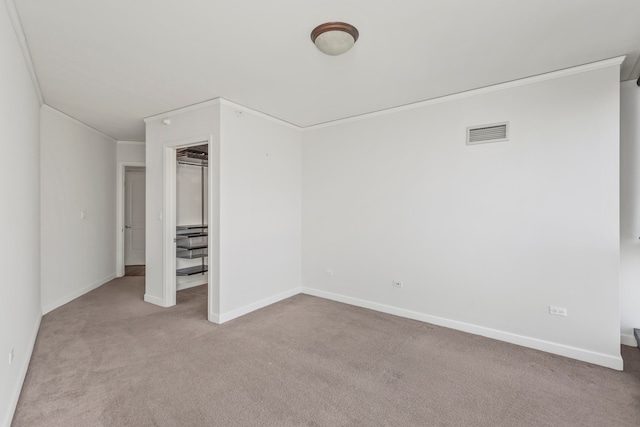 unfurnished bedroom with crown molding and light carpet