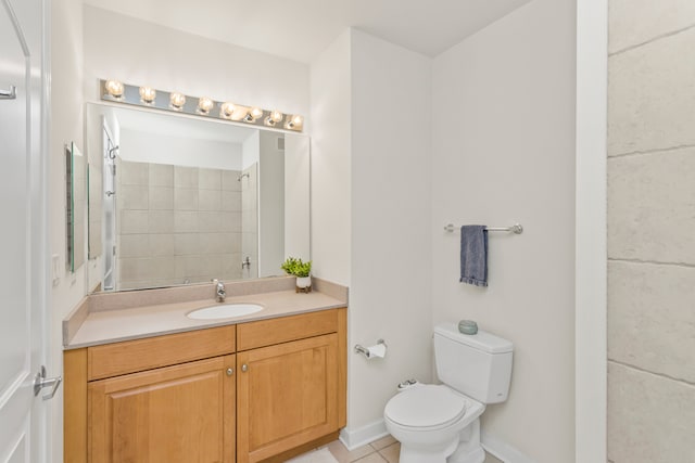 bathroom with tile patterned flooring, vanity, and toilet