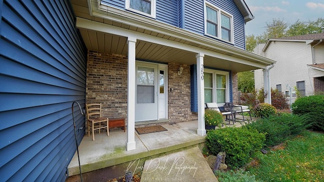 doorway to property featuring covered porch