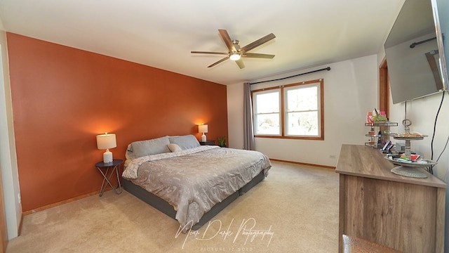 bedroom featuring light colored carpet and ceiling fan