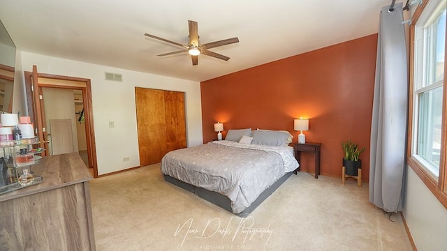 carpeted bedroom with a closet and ceiling fan